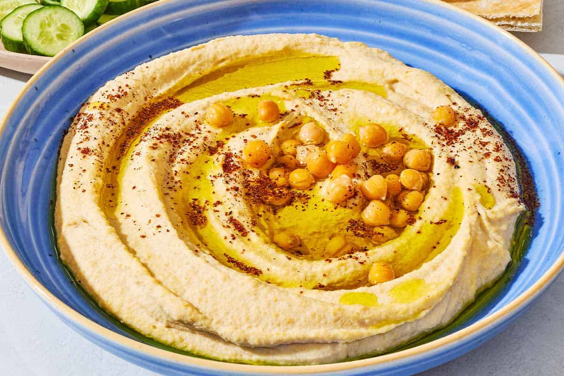 Creamy homemade hummus topped with olive oil and sumac served with pita bread.
