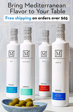 Four bottles of Mediterranean olive oil with a bowl of olives on a wooden surface, featuring free shipping promotion.