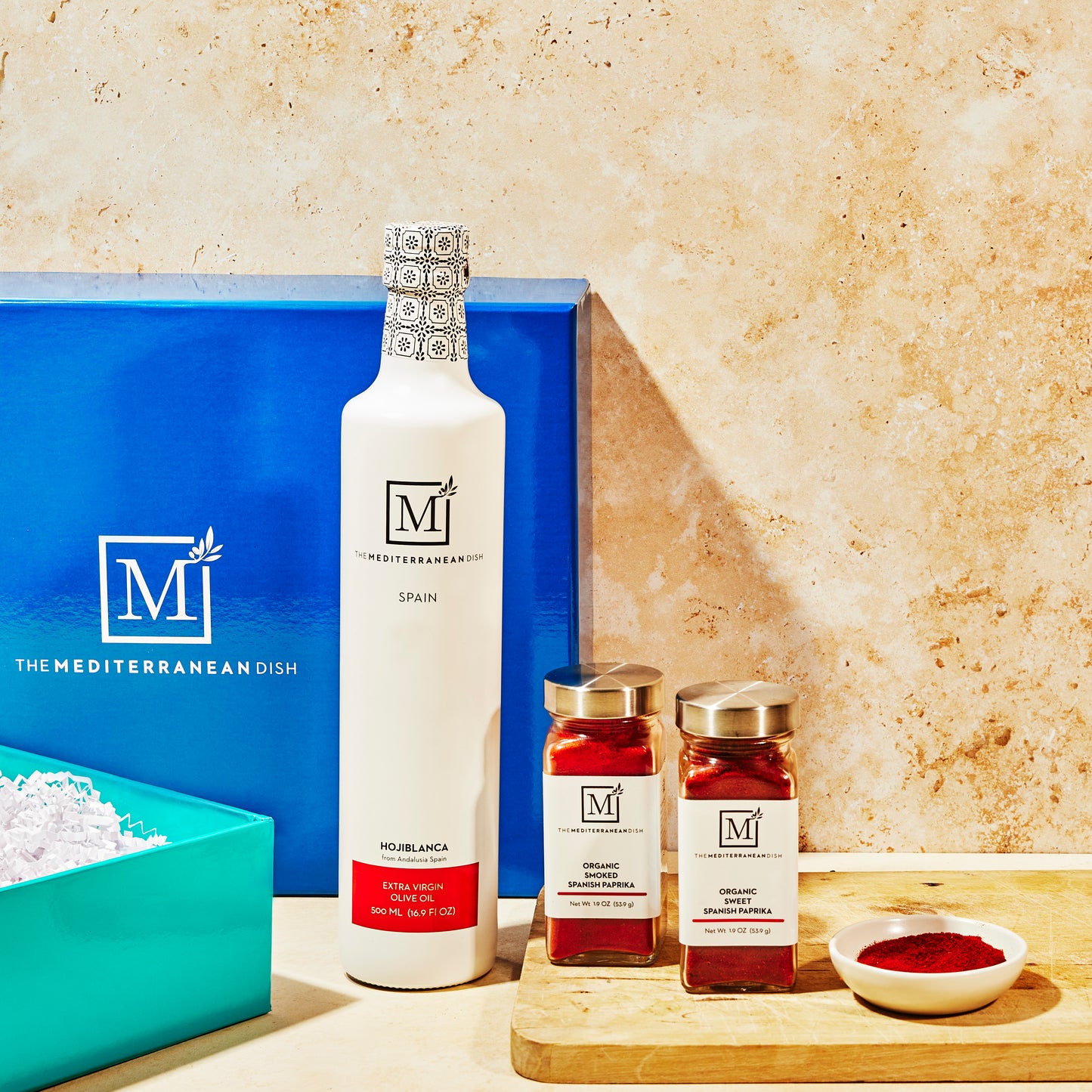 Bottles and jars with 'The Mediterranean Dish' branding on a kitchen counter.