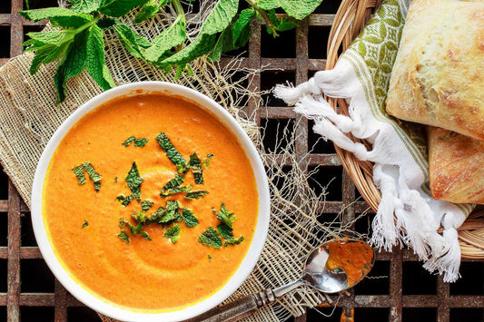 Bowl of roasted carrot ginger soup with side of bread