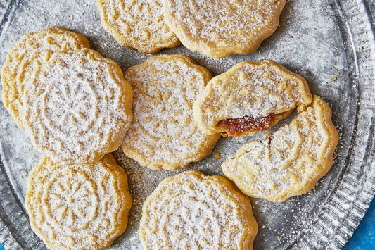 An overhead photo of date-filled cookies topped with powdered sugar.