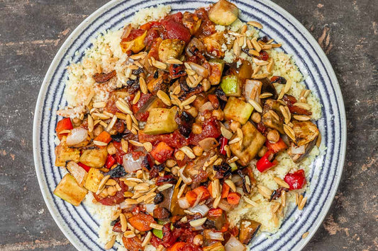 An overhead photo of a plate filled with couscous and topped with roasted vegetables.