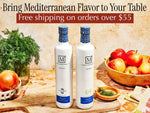 Two bottles of The Mediterranean Dish olive oil on a table with fruits and herbs, promoting Mediterranean flavor and free shipping.