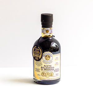 Bottle of Mussini Balsamic Vinegar on a white background.