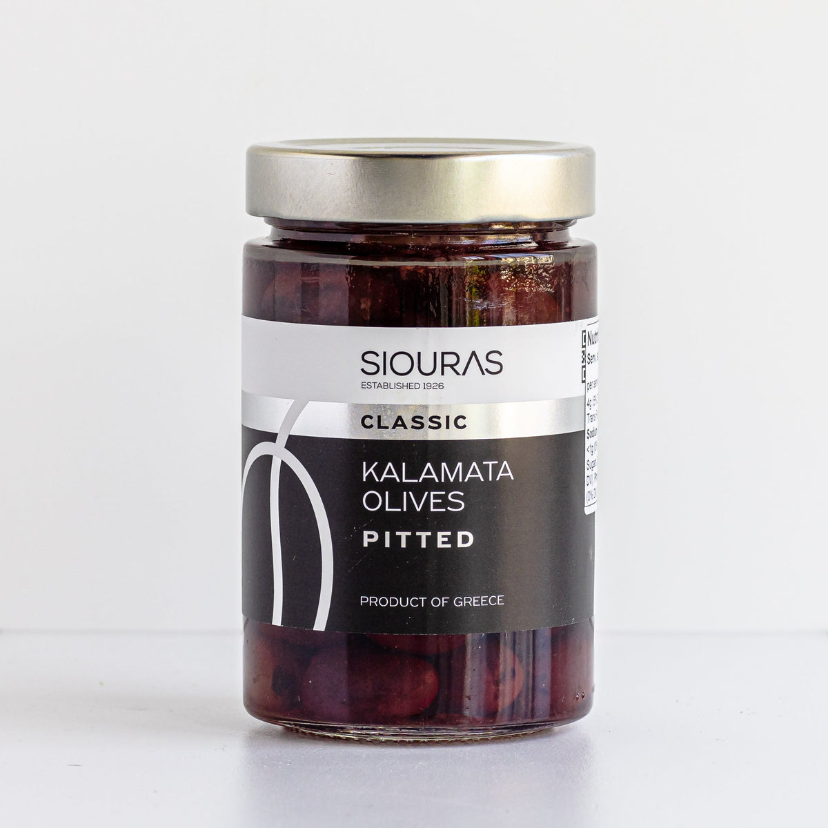 A jar of Greek Kalamata pitted olives with a silver cap on a clean white background. 