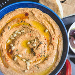 Dish of roasted red pepper hummus